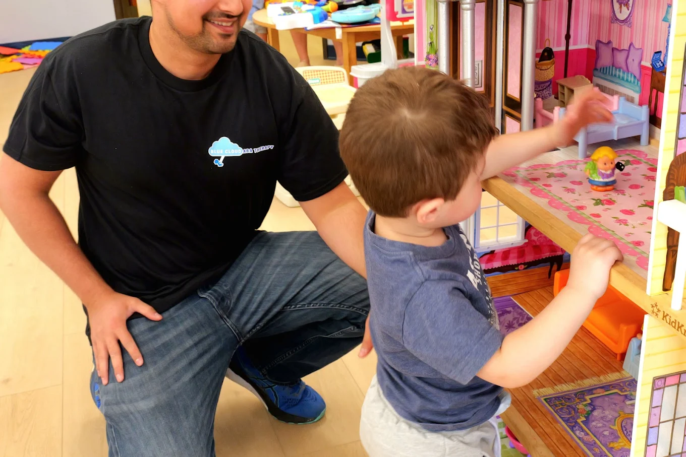 Therapist working with child during play-based ABA session